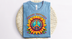 Blue shirt mockup of an image that says Choose Happiness over top of a sunflower with a peace symbol in the middle