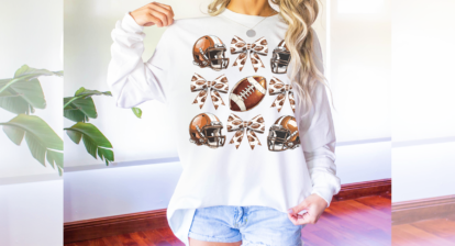 Football and bows illustration on a white long sleeve t-shirt.